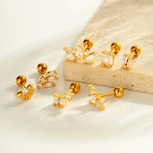 Set of 7 gold geometric zircon earrings on stone pedestal, elegant jewelry collection