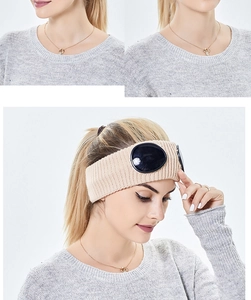 Detail of beige ribbed knit headband featuring integrated black goggles for winter warmth