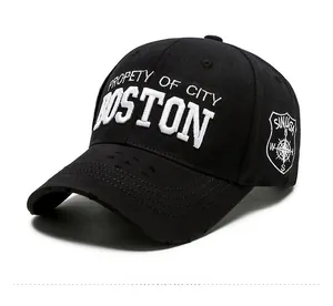 Close-up of Boston embroidery and side compass patch on black distressed cotton cap