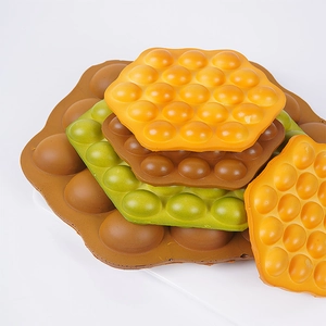 Artificial bubble waffle models in orange, green, and brown for window display