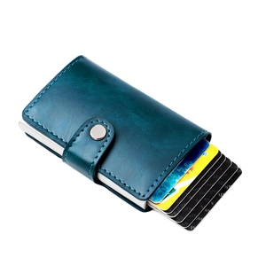 Macro shot of dark blue leather wallet with RFID blocking metal card holder detail