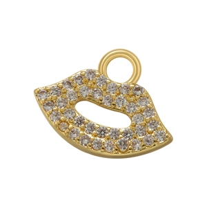Macro shot of gold lip pendant paved with micro cubic zirconia for jewelry making