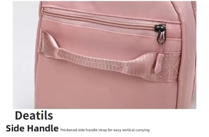 Close-up of pink yoga travel bag with reinforced webbing handle and side zipper pocket