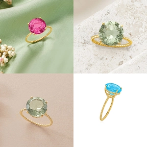 Detail showing four colors of round cut gemstone rings with twisted rope gold band design