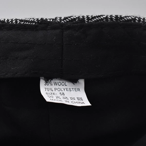 Detailed view of the cap's wool blend fabric inner lining and quality care label