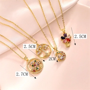 Detailed size comparison of gold necklaces with colorful zircon pendants on pink silk