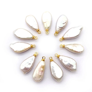 Baroque teardrop freshwater pearl pendants with gold loops arranged in a circle