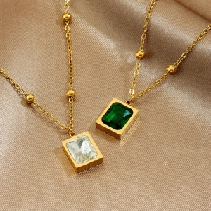 Gold plated stainless steel necklace with emerald and white square gem pendants