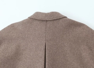 Close-up of the collar stitching and wool blend fabric texture on the brown coat