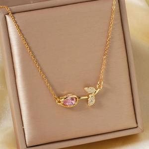 Detailed view of rose pendant necklace with pink pear-cut stone in jewelry box