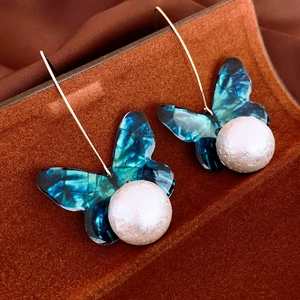 Elegant acrylic butterfly earrings with large white imitation pearls and silver hooks