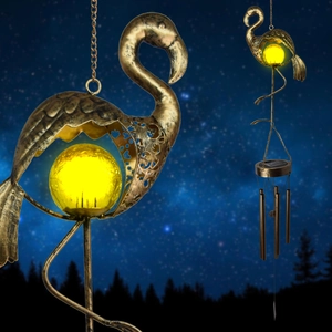 Solar bronze flamingo wind chime with glowing yellow glass ball in starry night setting
