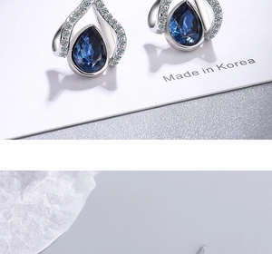 Detail view of water drop blue crystal earrings with silver plating and zircon stones