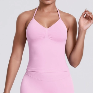 Detail of light pink halter neck sports bra with V-neck pleats and high-elastic fabric
