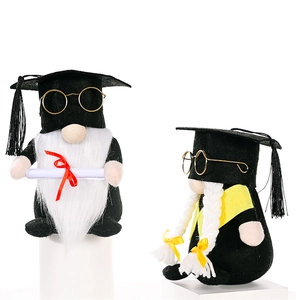 Close-up of graduation gnomes with black mortarboards, glasses, and felt diploma detail