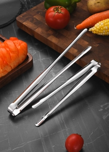 Close-up of SUS 304 stainless steel food tongs with serrated tips and etched material logo