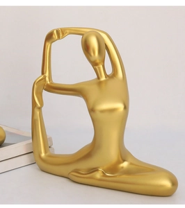Macro view of abstract golden yoga figurine with matte metallic finish for home decor