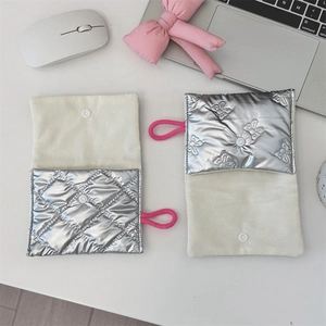 Detail showing silver quilted heart cosmetic bags with beige canvas and pink elastic loop