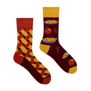 Detail of asymmetric socks showing red plaid pattern and apple pie jacquard motifs