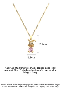 Macro detail of gold rabbit pendant with pink stone and titanium steel chain dimensions