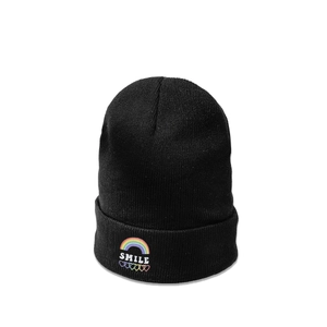Close-up of the colorful SMILE and rainbow heart embroidery on this black knit beanie