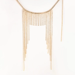 Detail shot of golden tassel headpiece with sparkling rhinestones and cascading fringe chains