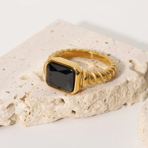 Macro shot of 18K gold-plated twisted ring with a large black rectangular zircon stone