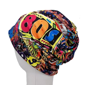 Close-up of 80s graffiti print on slouchy beanie with cassette and boombox patterns