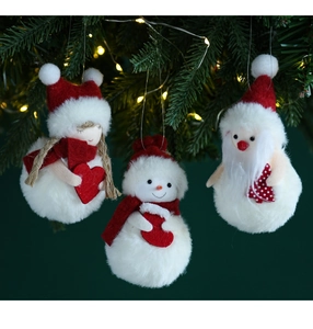 Detail of plush snowman and Santa ornaments hanging on a Christmas tree branch