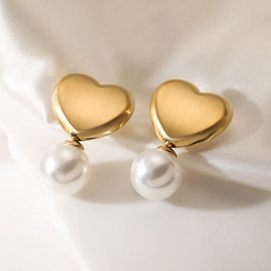 Matte 18K gold plated heart and white pearl stud earrings on white silk fabric