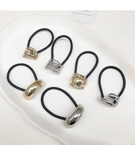 Detail view of 6-piece elastic hair ties with gold and silver metal geometric accents
