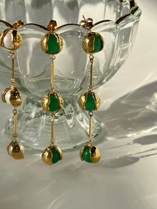 Detailed macro view of vintage 18k gold earrings with green chalcedony and white pearls