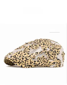 Detail of khaki leopard print mesh fabric on a breathable newsboy beret for women