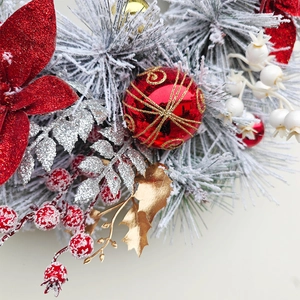 Christmas wreath with flocked pine needles, red glitter flowers and gold ornaments