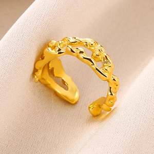 Macro shot of 18K gold teardrop ring with wavy texture and adjustable open band design