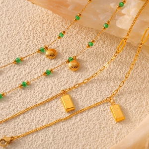 French vintage gold anklet featuring shell pendant, green beads and rectangular gold bar