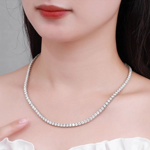 Luxury 925 sterling silver moissanite tennis necklace worn by a model on grey background