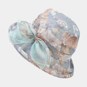 Detail of floral embroidery and light green mesh bow on breathable grey sun hat