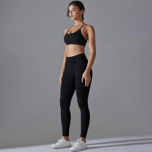 Close-up of black seamless knit yoga set with cross-back sports bra and high-waist leggings