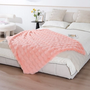 Detailed view of pink faux fur blanket featuring a soft wavy texture and plush finish