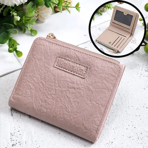 Detail view of pinkish-purple short wallet featuring wrinkled PU leather and card slots