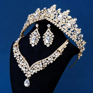 Exquisite bridal jewelry set with sparkling crystals and gold tiara on display stand