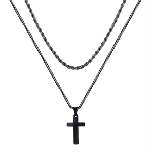 Detail of a double-layered black stainless steel chain with a cross pendant necklace