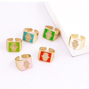 Detailed view of colorful Hamsa Hand enamel rings with micro-set zircon on adjustable bands