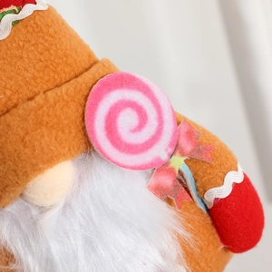 Handcrafted Christmas gingerbread gnome with white beard and lollipop decoration