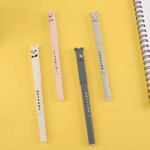 Flat lay of four erasable gel pens with cartoon animal designs on a yellow background