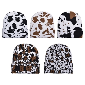 Winter knitted beanies in various cow print and animal patterns for outdoor warmth