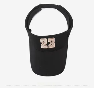 Close-up of black knitted sun visor with beige number 23 embroidery and top view detail