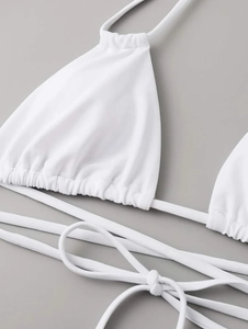 Detail of white triangle bikini top with drawstring cups and fine stitching texture