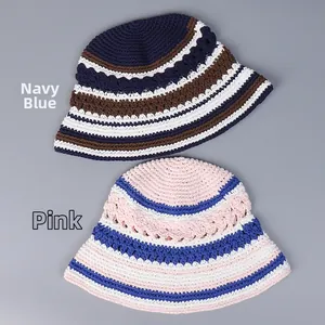 Detail showing the intricate open-work crochet knit texture of two striped bucket hats